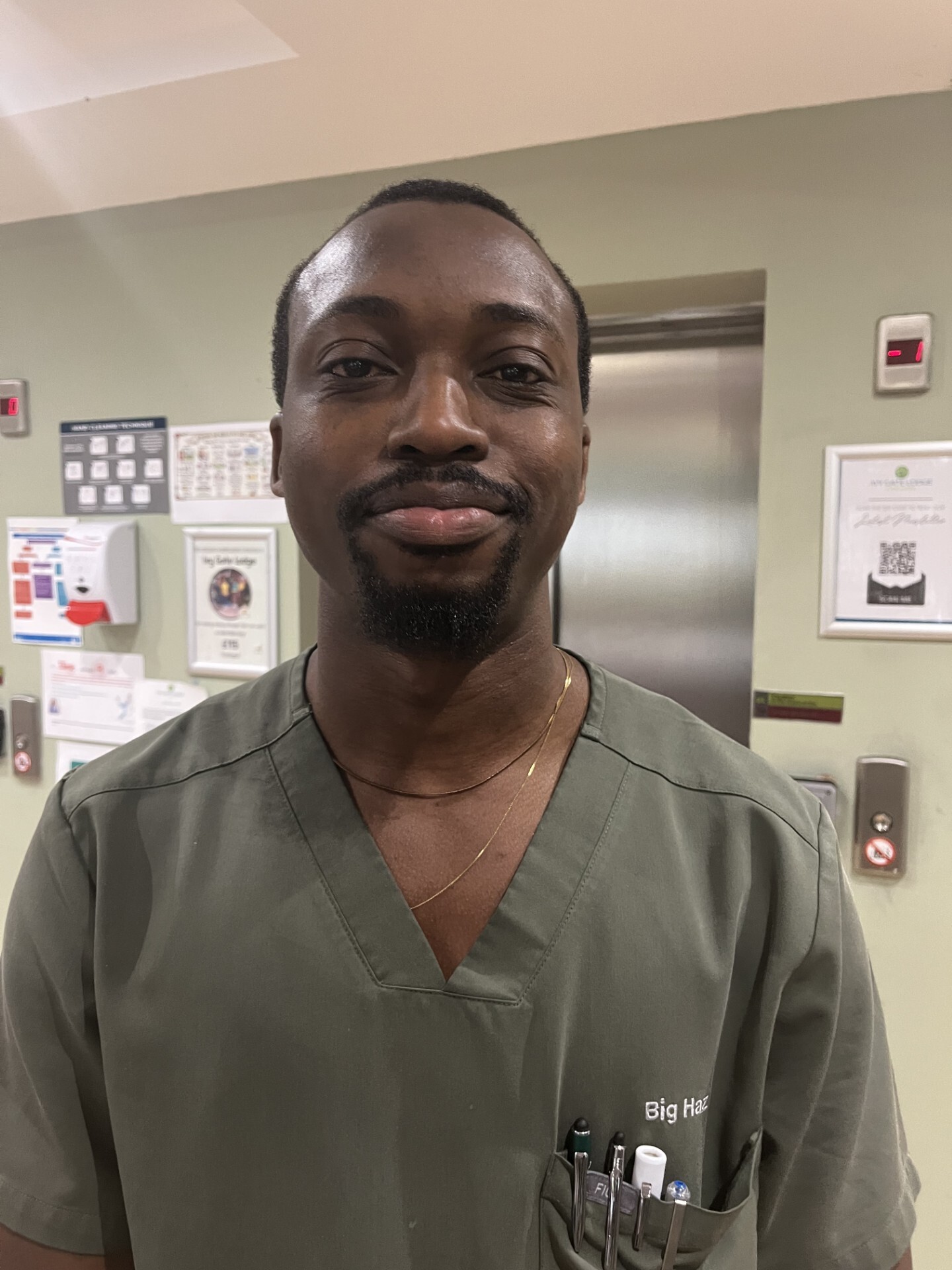 man in care uniform posing for staff photo