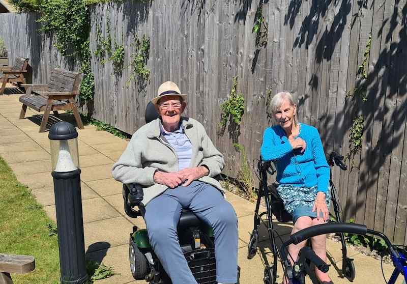 2 of our residents sat in the garden together smiling