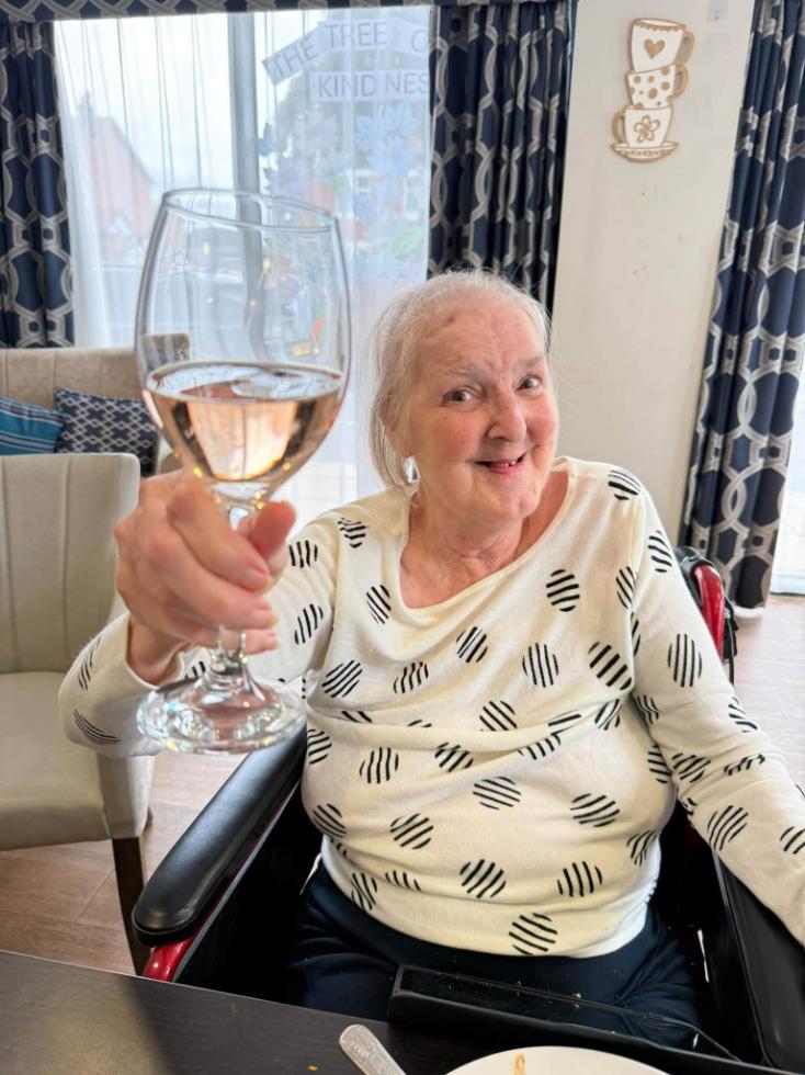 older lady holding a wine glass