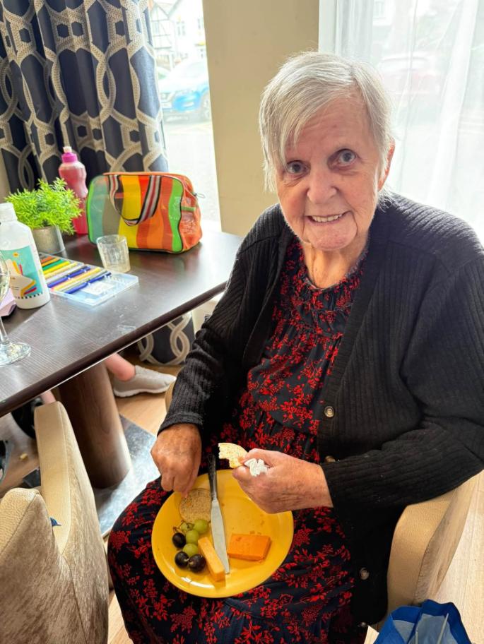older lady sat smiling