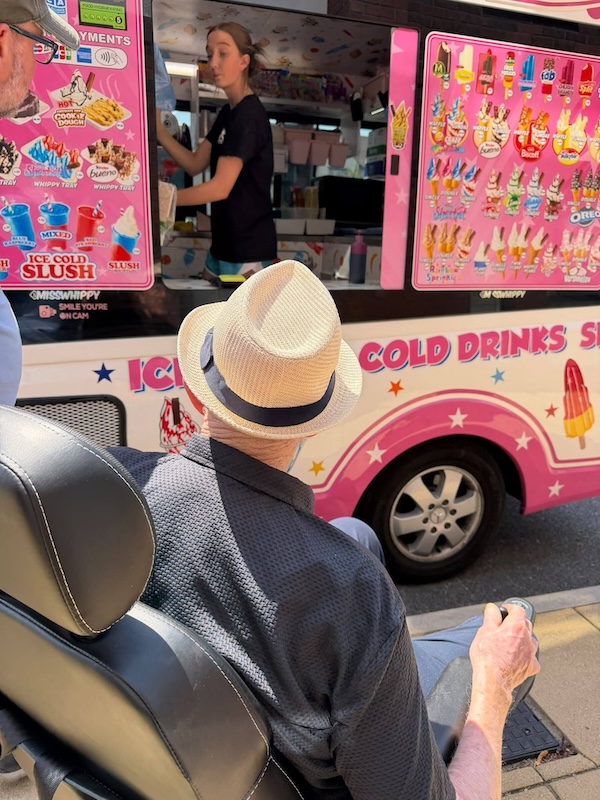 resident in wheelchair next to ice cream van