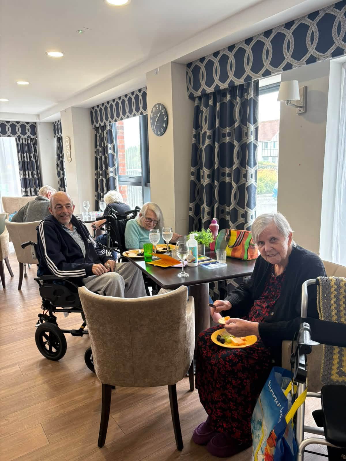 residents sat a table smiling